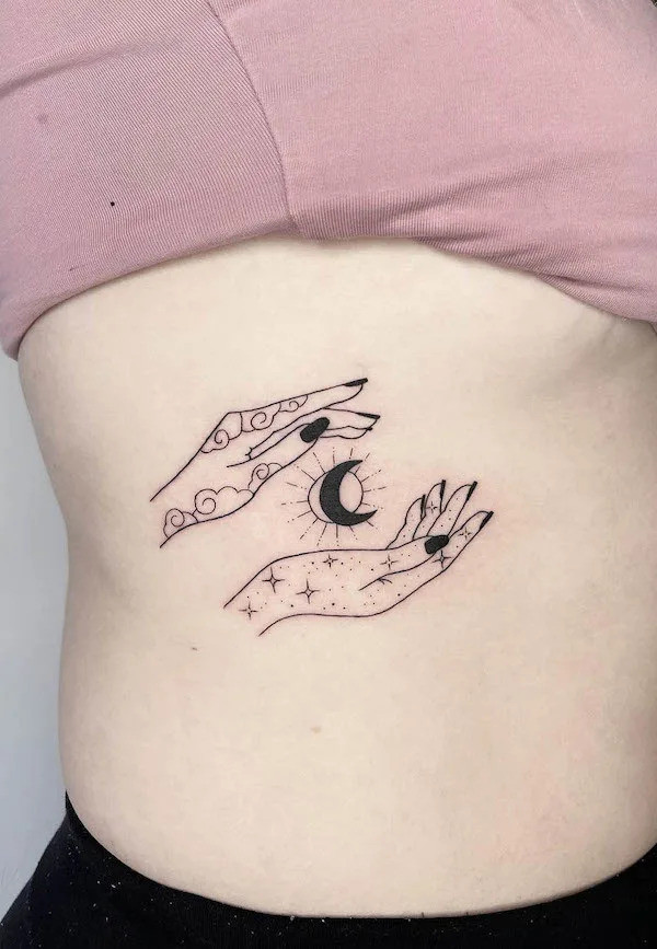 Hands Holding Black Moon Rib Tattoo